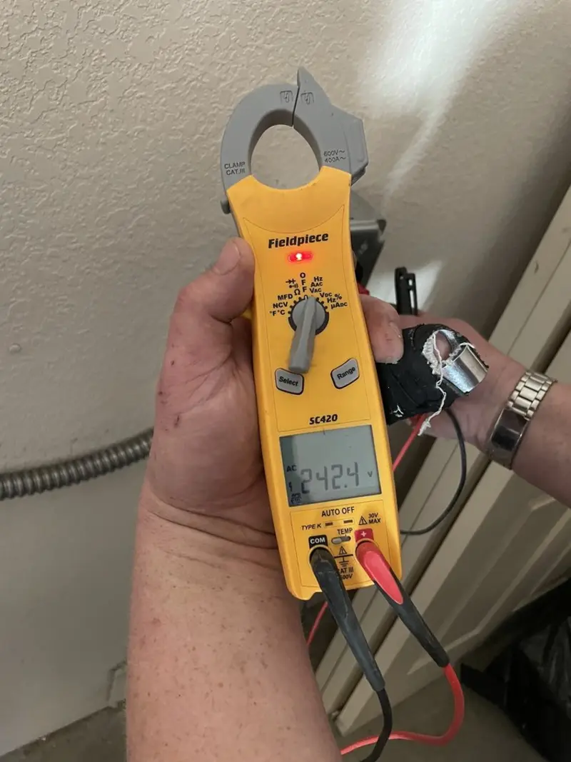 Voltage testing with clamp meter during Ceiling Fan Installation in Lee
